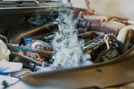 Smoke from car engine indicating overheating